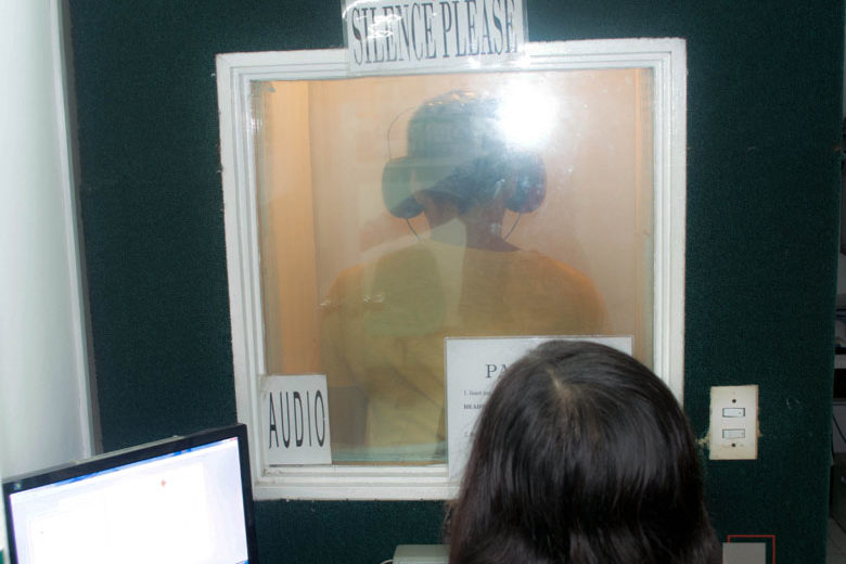 Image of an american outpatient clinic employee performing an audiometry examination on an applicant
